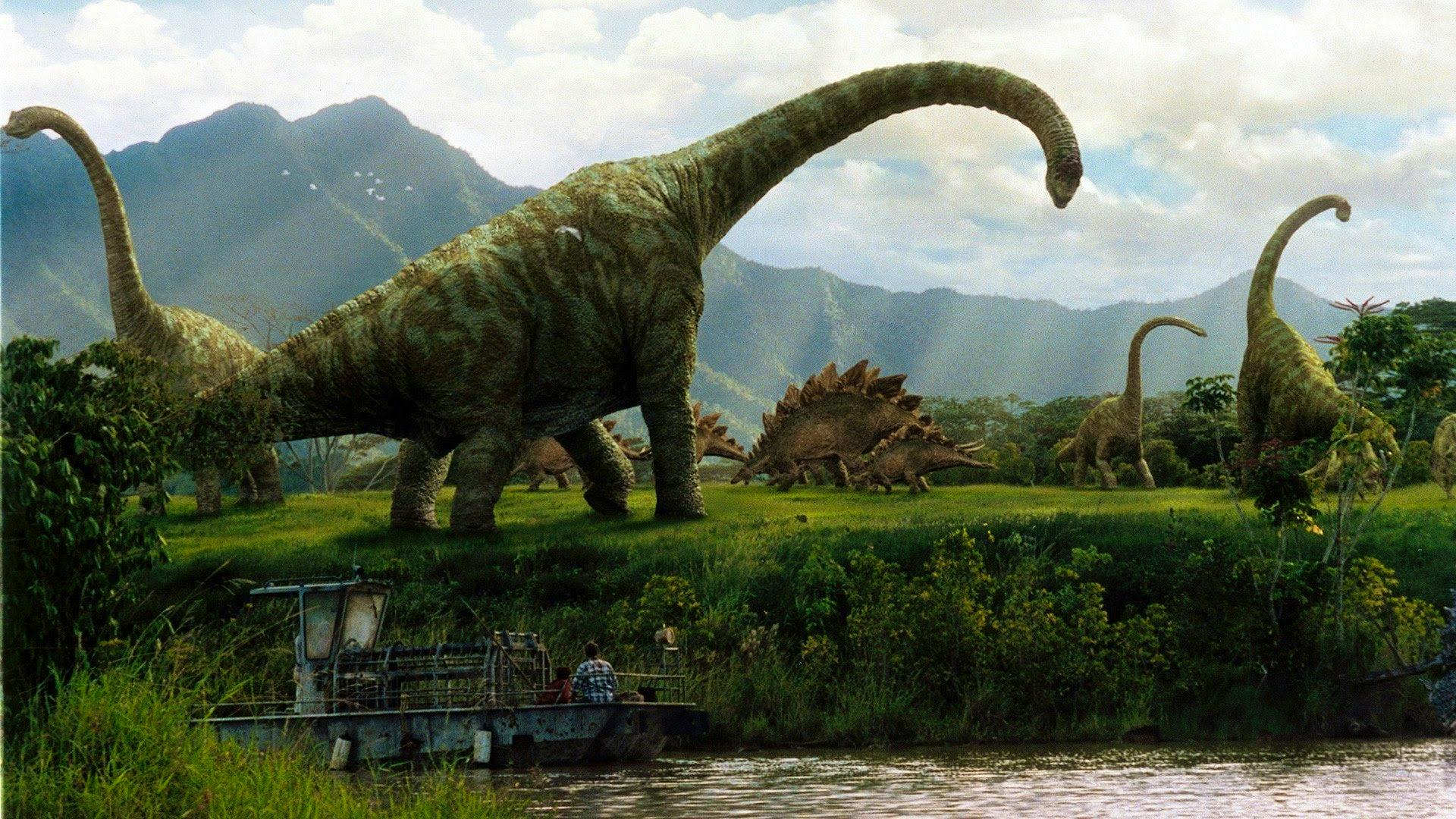 A riverboat floats past a herd of gigantic sauropod dinosaurs.